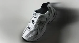 Close-up of a New Balance 530 Sneaker in white with black accents, showcasing its sleek design and breathable mesh material.