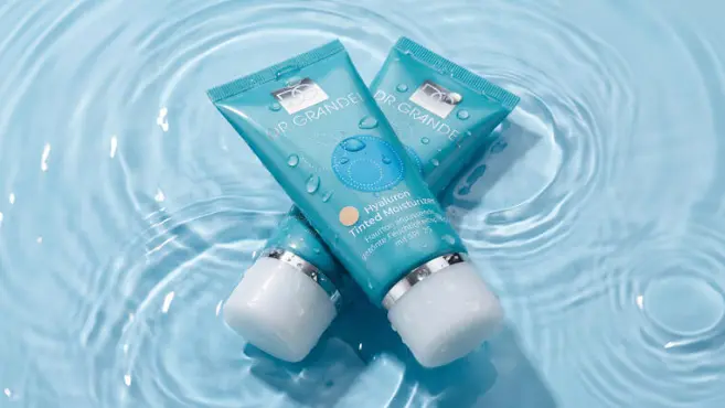 DR. GRANDEL Hyaluron Tinted Moisturizer SPF 25 tubes in water.