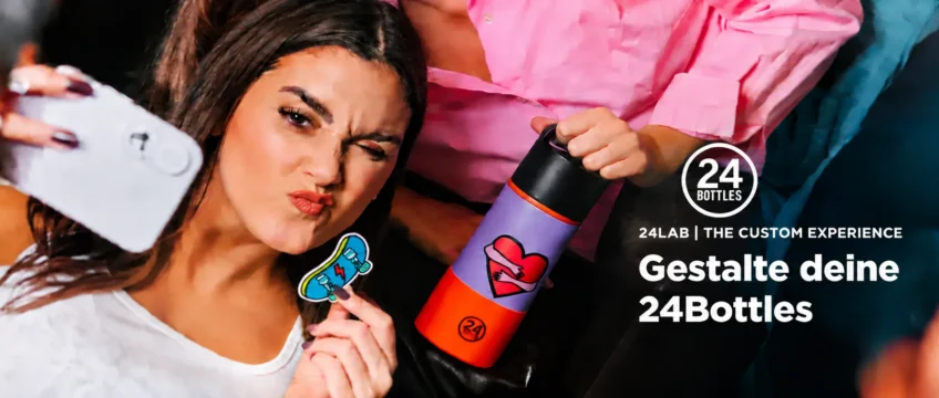 Young woman taking a playful selfie with a customized 24Bottles water bottle featuring a colorful design.